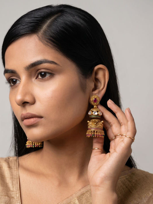 Antique gold double Jhumka earrings with Kundan stones, ruby centre, floral detailing and colourful bead tassels.