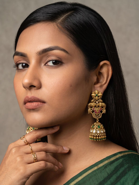 Antique gold elephant temple jhumka earrings featuring Kundan Polki, green synthetic stones, floral detailing and a traditional dome-shaped design