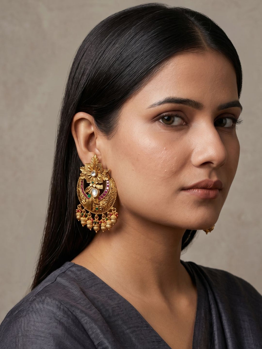 Antique gold Chandbali earrings with floral detailing, Kundan Polki stones, ruby and emerald accents and elegant bead danglers