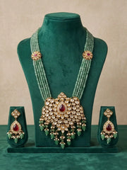Close view of multiple strands of glossy green jade beads with kundan brooches and gold-plated detailing creating a rich layered appearance