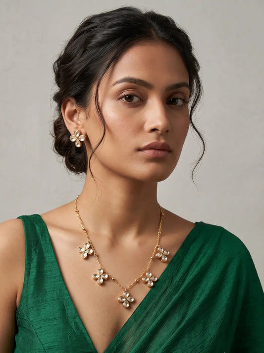 A women in a green saree is wearing a Delicate Minimal Chain Necklace Set With Floral Polki Drops | Statement Jewellery Set