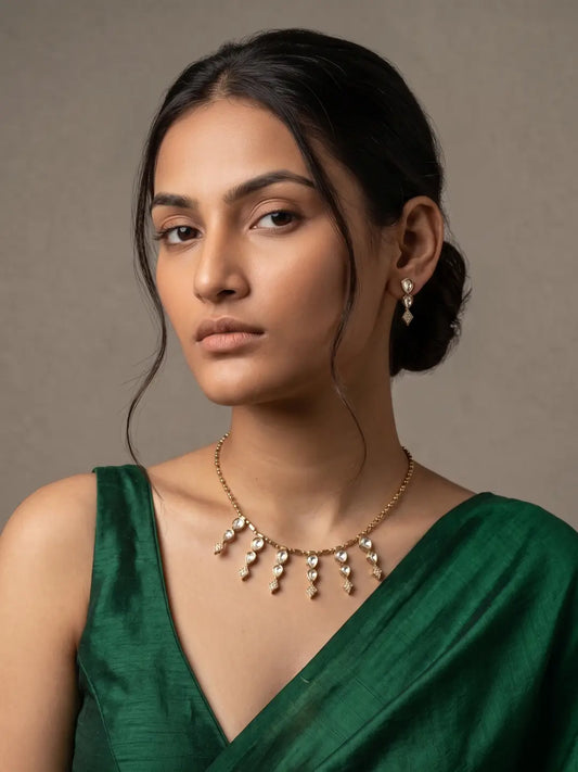 A woman is wearing an elegant Victorian Finish Minimal Chain Necklace With Polki Drops | Indo Western Jewellery