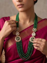 Emerald green layered necklace with natural jade beads, Kundan Polki floral brooches and gold-plated detailing for bridal and wedding styling.