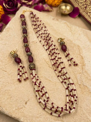 Matching earrings with coordinated red and brown bead accents and gold-toned detailing, designed to echo the layered necklace