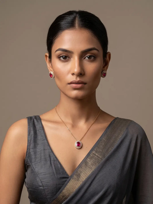 Gold-plated minimal jewellery set featuring a delicate chain necklace, oval red Kundan and CZ pendant, and matching stud earrings for women