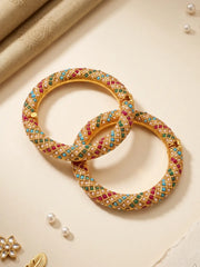 Gold plated multicolor Jadau bangles with closely placed stones and pearl accents, designed for bridal, wedding and festive jewellery styling.