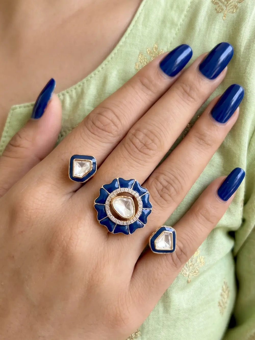 Navy blue gold plated Kundan double finger ring with enamel and Polki stones, designed as a statement accessory for weddings and celebrations.