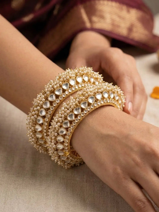 Women's hand wearing a Traditional Gold Plated Pearls & Paachi Kundan Jadau Gokhru Bangles | Statement Kada Bangles