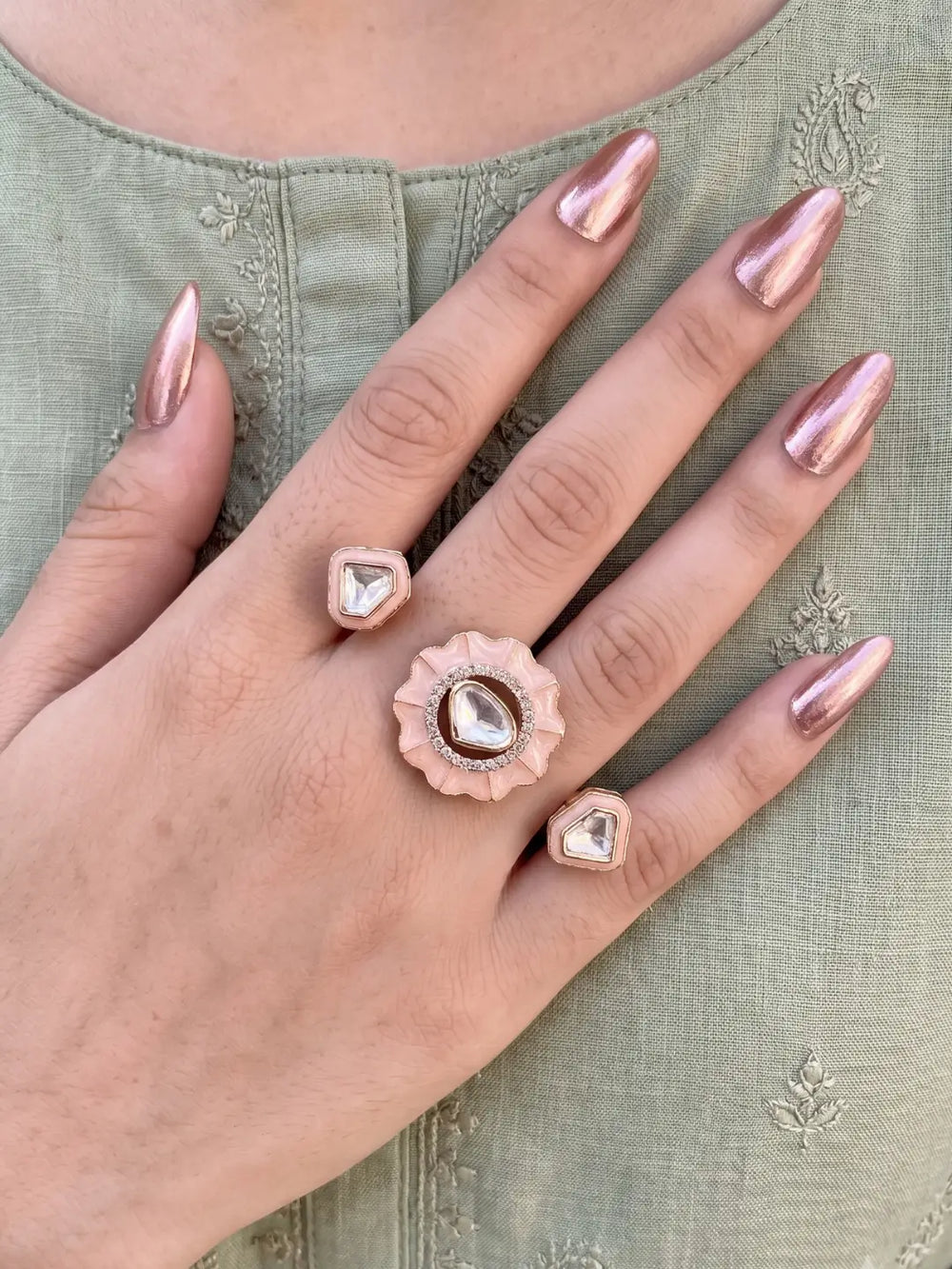 Pink gold plated Kundan double finger ring with enamel and Polki stones, a statement jewelry piece for mehendi, weddings and festive celebrations.