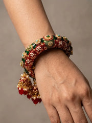 Gold plated red Meenakari kada bangle featuring Kundan-style stones, synthetic pearls and floral detailing for traditional bridal styling.