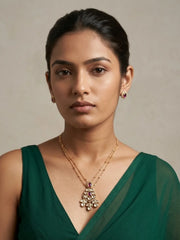 Gold plated necklace set featuring a red teardrop Polki pendant and matching red stone stud earrings with sparkling CZ accents.
