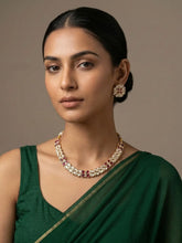 A women wearing Gold Plated Kundan Necklace And Earring Set wirh ruby stones on a green saree | Festive And Wedding Wear Jewellery