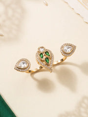 Green CZ and Polki-style double finger ring with gold plating and pear-shaped motifs, styled as a statement accessory for ethnic outfits.