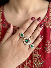 Green dual-finger Polki ring with a floral centre, matching pear-shaped motifs, CZ stone detailing and a gold-plated finish.