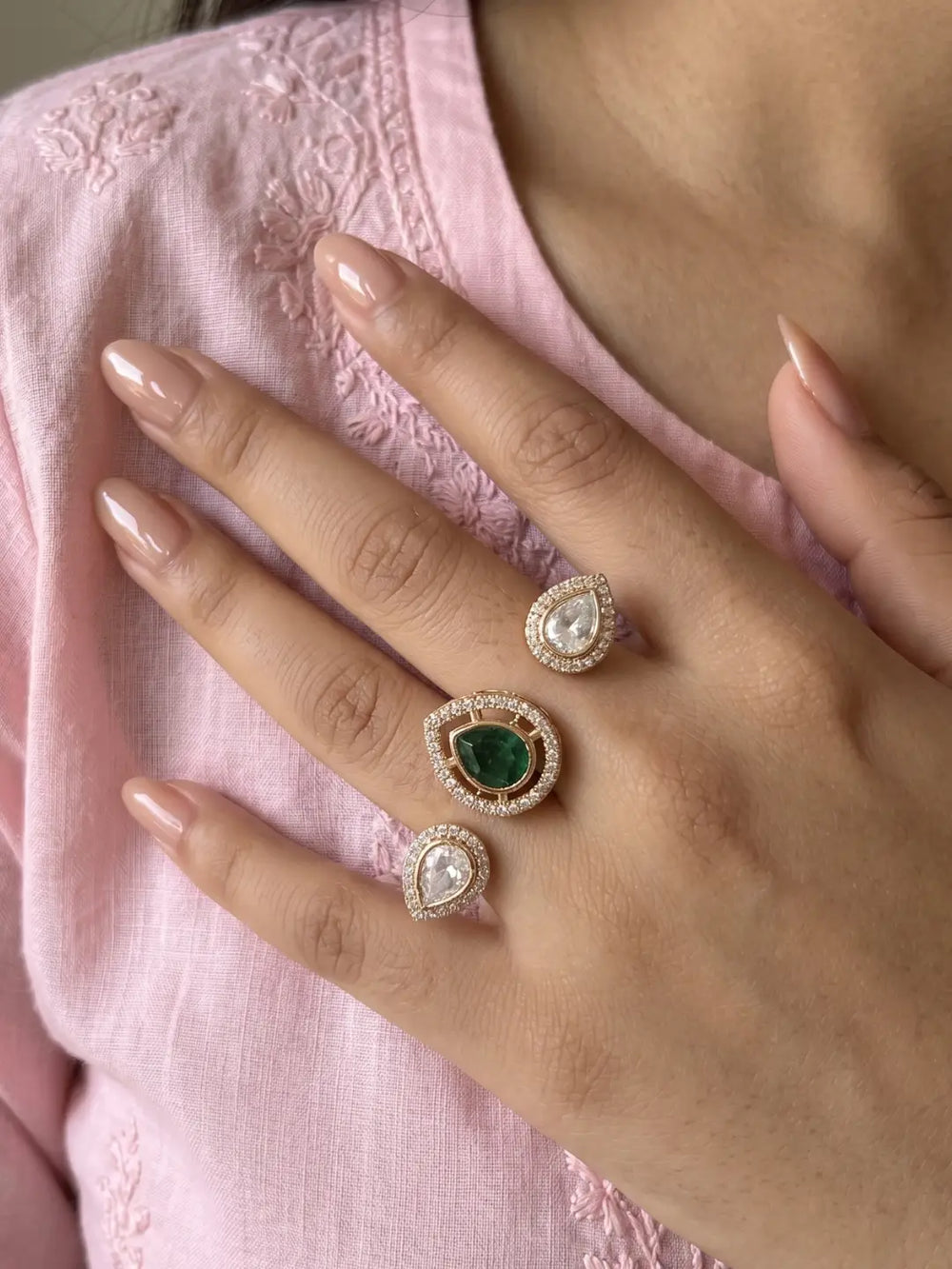 Green gold plated Kundan Polki dual finger ring with pear-shaped CZ details, styled as a statement piece for bridal and festive occasions.