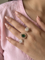 Green gold plated Kundan Polki dual finger ring with pear-shaped CZ details, styled as a statement piece for bridal and festive occasions.