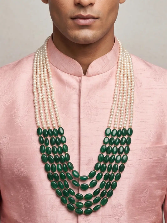 Layered white shell pearl groom mala with polished green jade beads for an elegant Indian sherwani wedding look