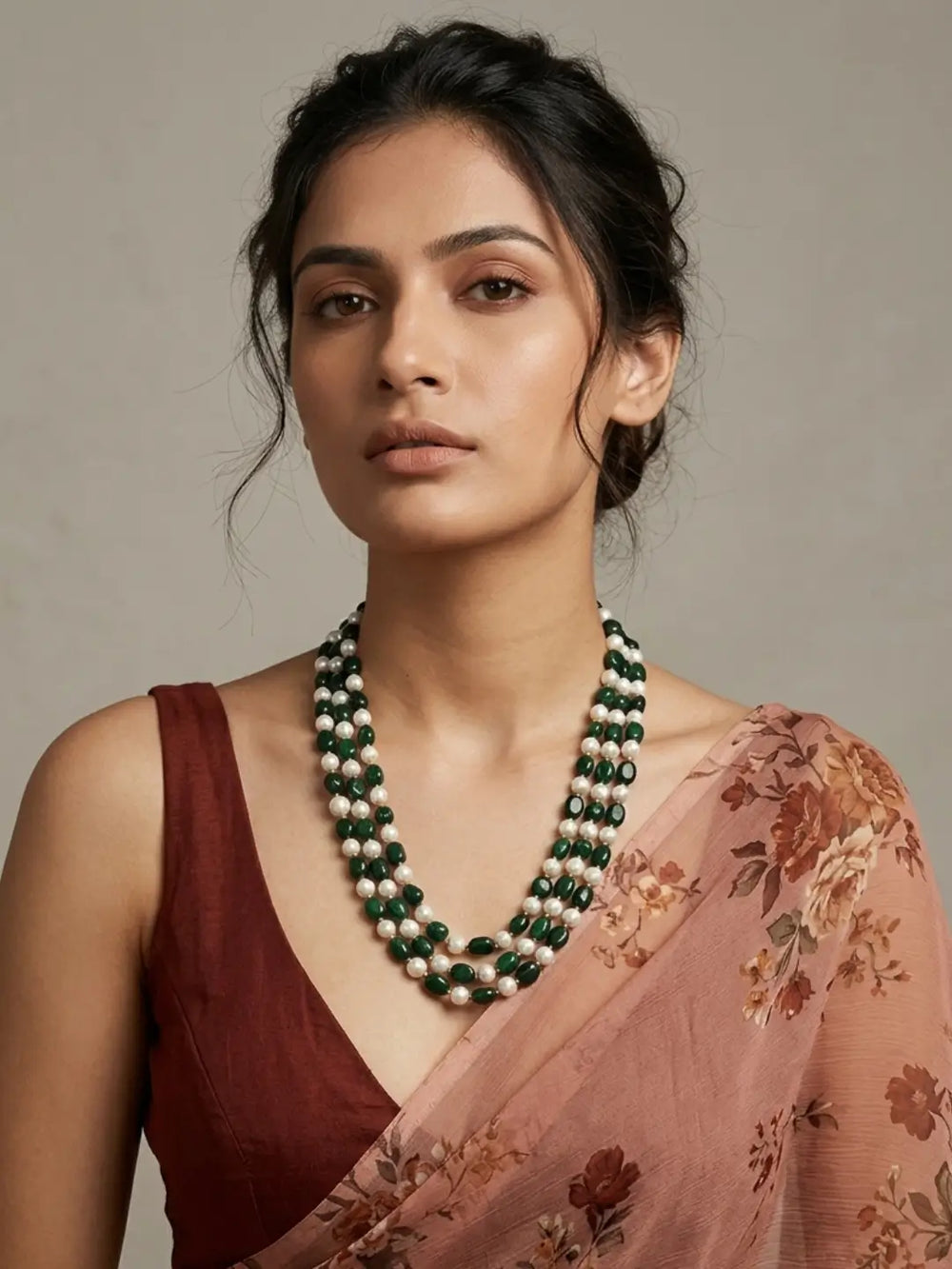 Triple-layer mala necklace with alternating green jade beads and faux pearl beads in graduated strands and gold-plated detailing