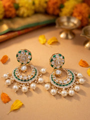 Green gold plated Chandbali earrings with Polki and Kundan detailing, emerald enamel accents and delicate pearl danglers for wedding looks.