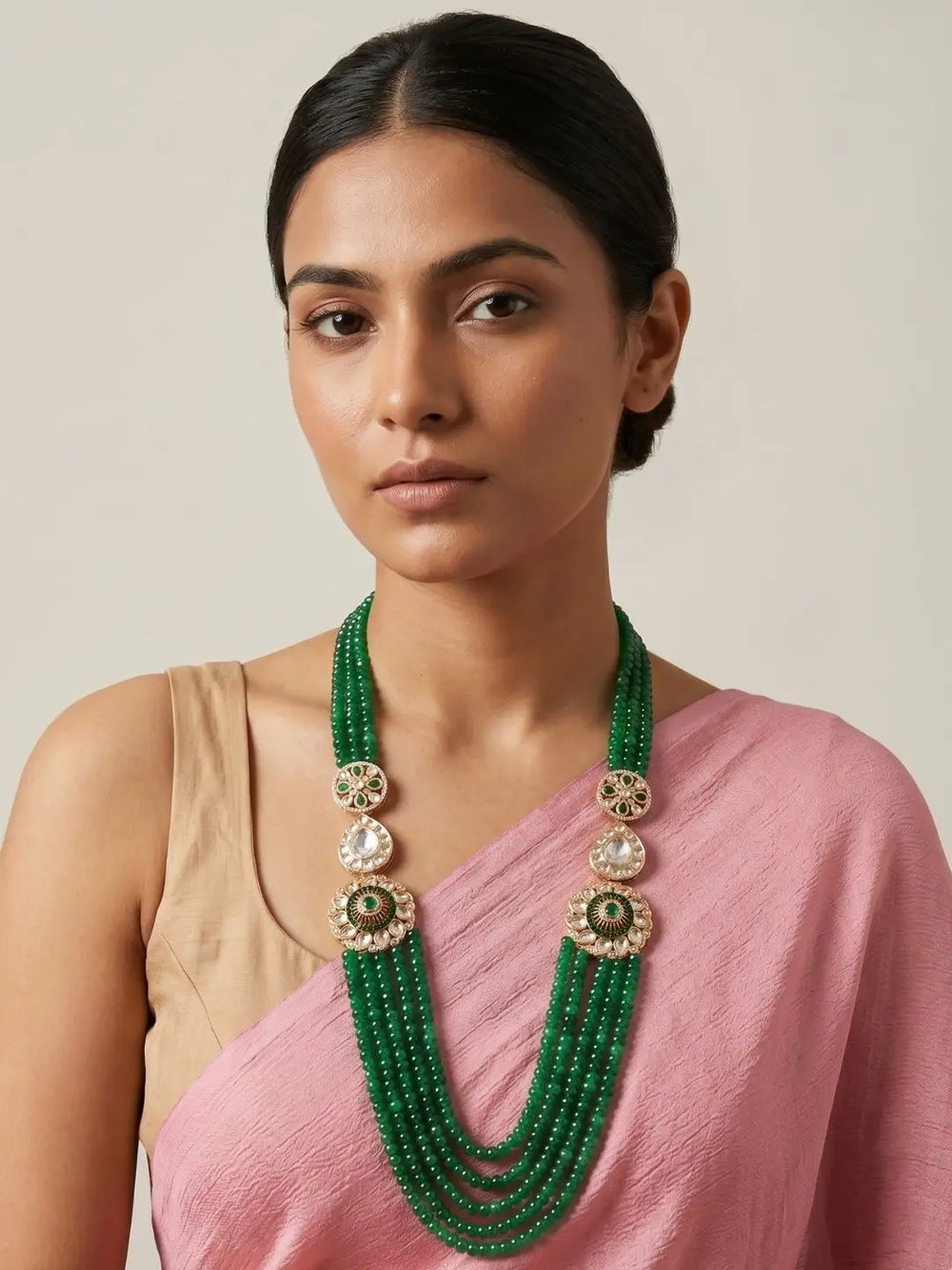 Green Kundan Polki layered beaded necklace with natural jade beads and floral motifs, styled with ethnic Indian wedding and festive outfits.