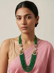 Green Kundan Polki layered beaded necklace with natural jade beads and floral motifs, styled with ethnic Indian wedding and festive outfits.