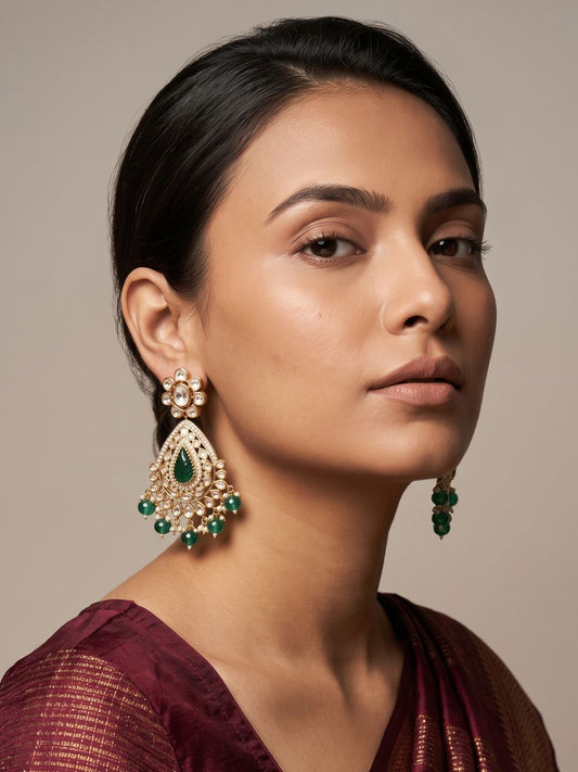 Green gold plated Kundan Polki Chandbali earrings with carved teardrop stones, sparkling detailing and pearl and stone bead drops.