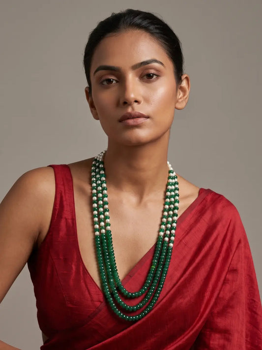 Green layered beaded mala with green and red jade beads, shell pearls and gold-plated detailing, designed for weddings and festive ethnic outfits.
