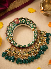 Green Meenakari wedding kada with Kundan-style stones, synthetic pearls and jhumka details, styled as a statement bridal bangle.