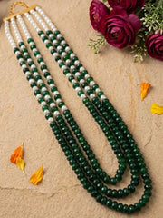 Green pearl and jade mala with layered red and green gemstone beads, shell pearls and gold-plated details for sarees, lehengas and weddings.