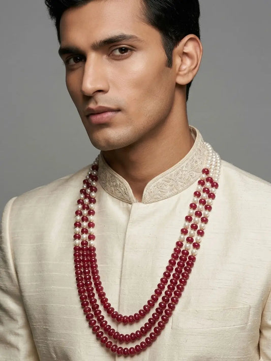 Layered groom sherwani mala with white shell pearl strands, faceted red jade beads and gold plated detailing for Indian weddings