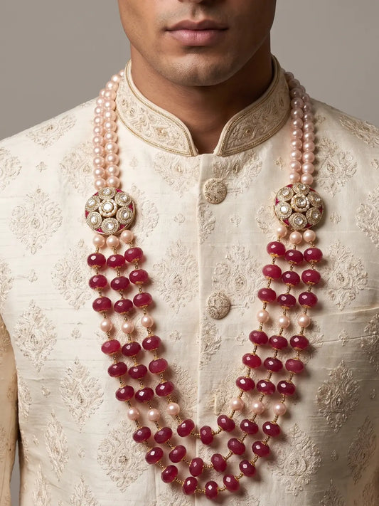 Layered dulha necklace featuring rich red gemstone beads, lustrous shell pearls, Kundan accents and a central Polki charm