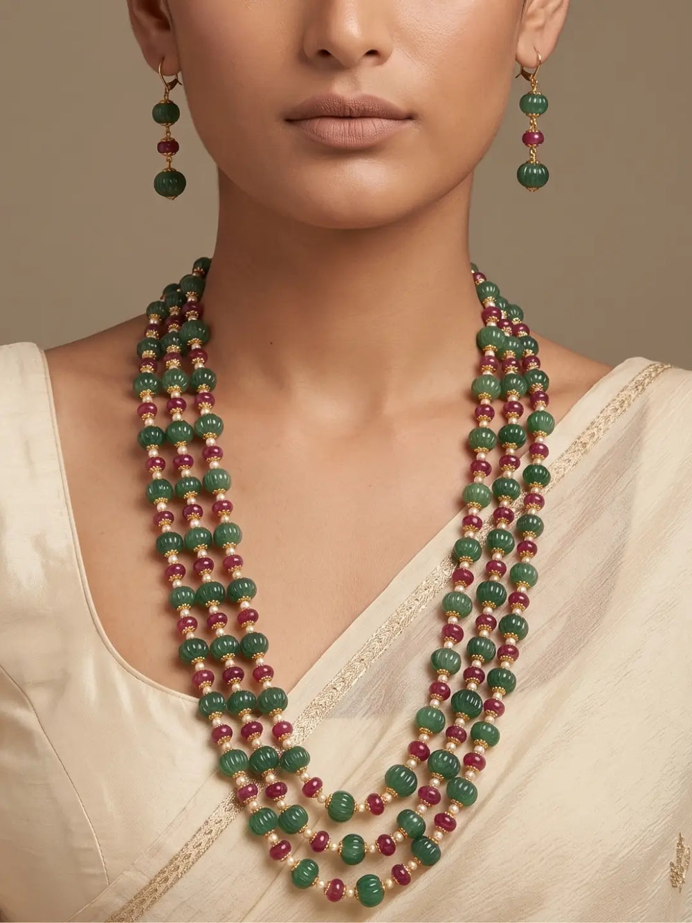 Layered ruby red and green jade beaded necklace set with pearl spacers and matching earrings for Indian weddings and festive occasions.
