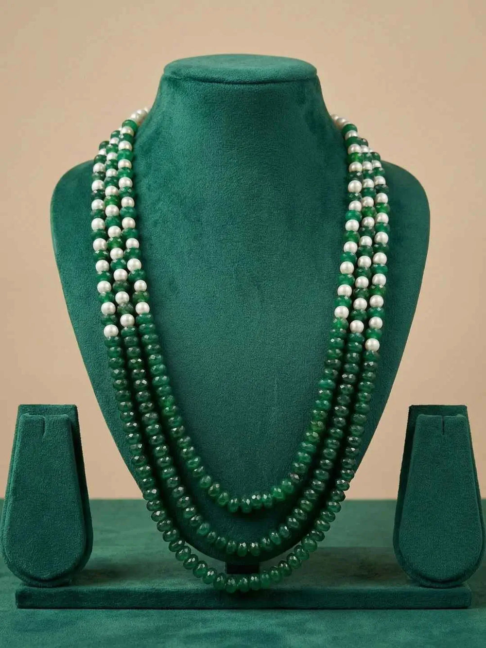 Long green beaded necklace with red and green jade gemstone beads and shell pearls, styled as layered ethnic jewellery for festive occasions.