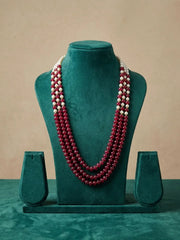 Long maroon beaded necklace with green and red jade gemstone beads and shell pearls, styled as layered ethnic jewellery for festive occasions.