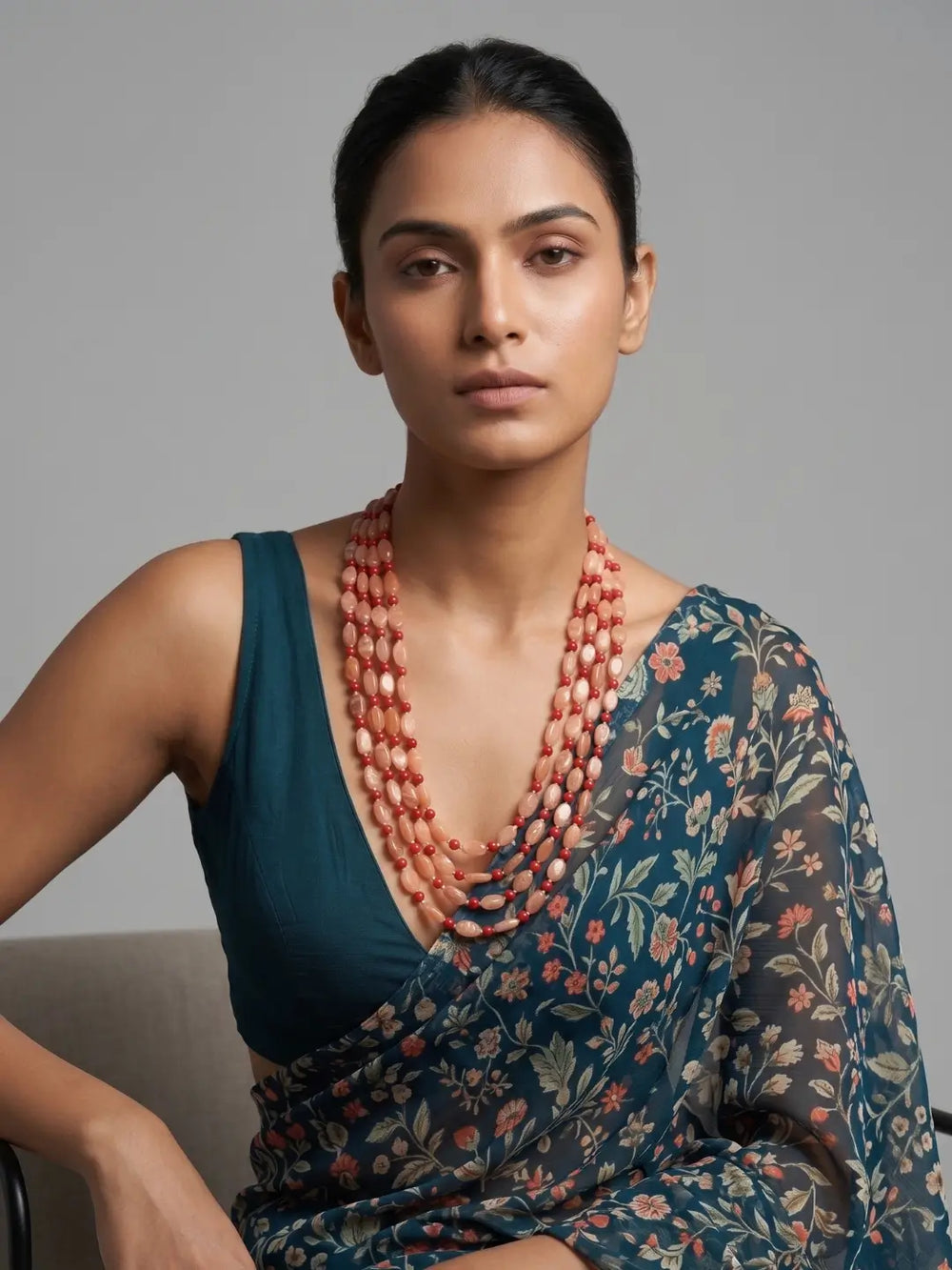 Long red coral and natural moonstone mala with layered strands and gold-plated details, designed for weddings, festive celebrations and ceremonies.