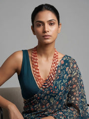 Long red coral and natural moonstone mala with layered strands and gold-plated details, designed for weddings, festive celebrations and ceremonies.