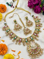 Pair of antique gold kundan earrings, 2 inches long, with ruby pink and emerald green stones matching the traditional necklace set