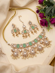 Coordinated mint green maang tikka featuring green doublet stones, white Kundan-style detailing, gold-tone ornamentation and pearl embellishments.