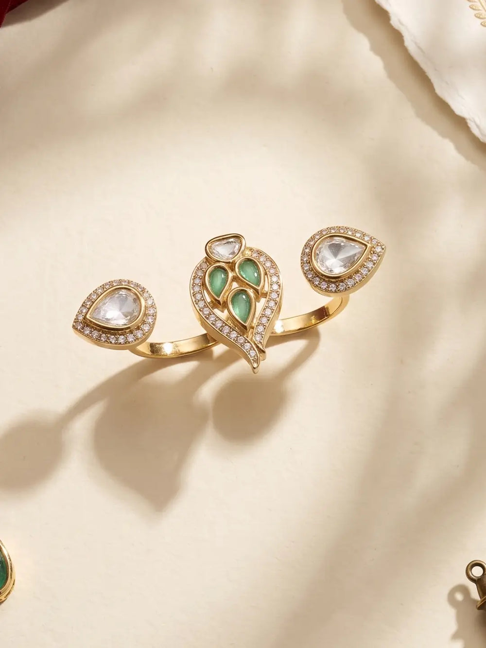 Mint green CZ and Polki-style double finger ring with gold plating and pear-shaped motifs, styled for ethnic, festive and party wear looks.