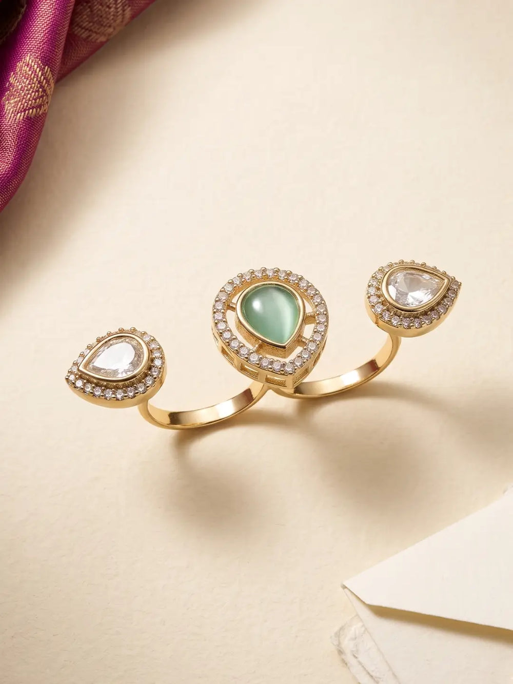 Mint green Kundan Polki dual finger ring with gold plating and pear-shaped CZ details, designed for bridal, wedding and ethnic jewellery styling.