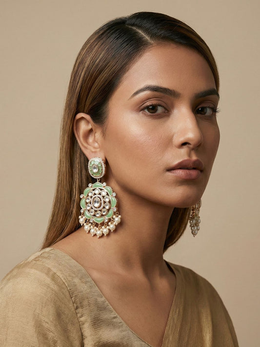 Mint green gold plated Kundan earrings with layered floral stonework, Polki detailing and pearl drops for bridal and festive ethnic looks.
