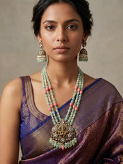 Mint green Lakshmi temple necklace featuring an ornate Goddess pendant, antique-style detailing, layered jade beads and matching jhumka earrings.