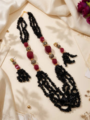 Long layered necklace with glossy black onyx chip strands, bold red jade beads and gold-tone spherical accents with black detailing