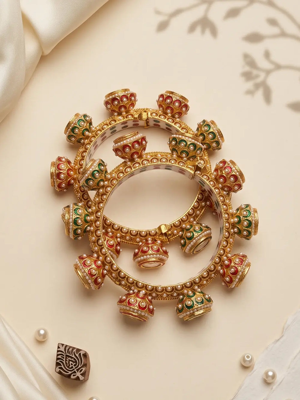 Multicolour Meenakari Kundan Gokhru kada bangles with white pearl detailing, red and green accents and gold-tone borders for festive looks.