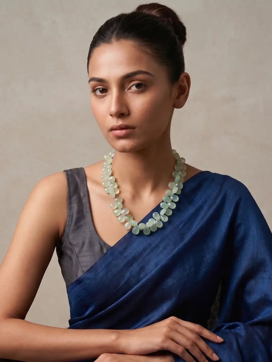 Women Wearing an Exquisite Handmade Natural Aqua Chalcedony Almond Shaped Beaded Necklace Set on a blue saree - Perfect Indo Western Gemstone Jewellery