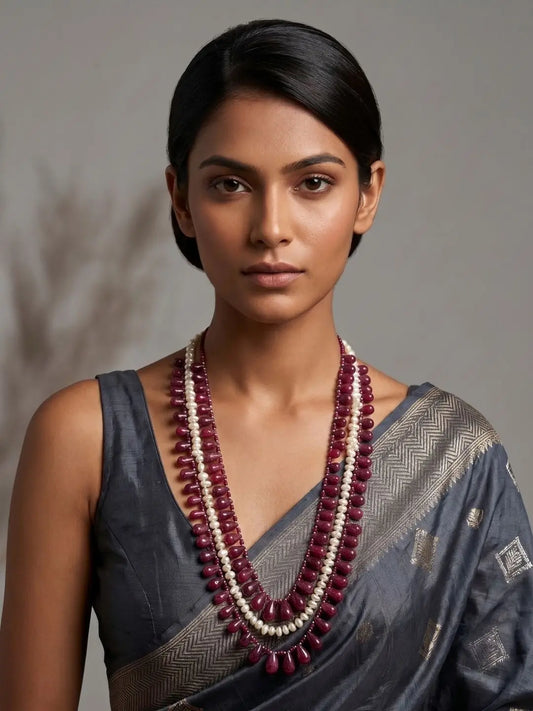 Woman wearing a long layered necklace featuring natural drop-shaped Ruby beads and Freshwater Pearl beads, creating an elegant gemstone jewellery look for ethnic wear.