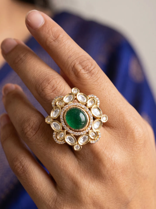 Oversized green Polki Kundan statement ring with a vivid emerald-green centre, sparkling white Polki stones and gold-tone floral detailing for weddings