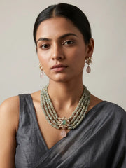 Pastel green aquamarine chip bead necklace with a floral Kundan pendant, pink teardrop stone drop and matching earrings.