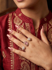 Pink gold plated Kundan Polki dual finger ring with pear-shaped CZ details, styled as a statement accessory for bridal, wedding and festive looks.