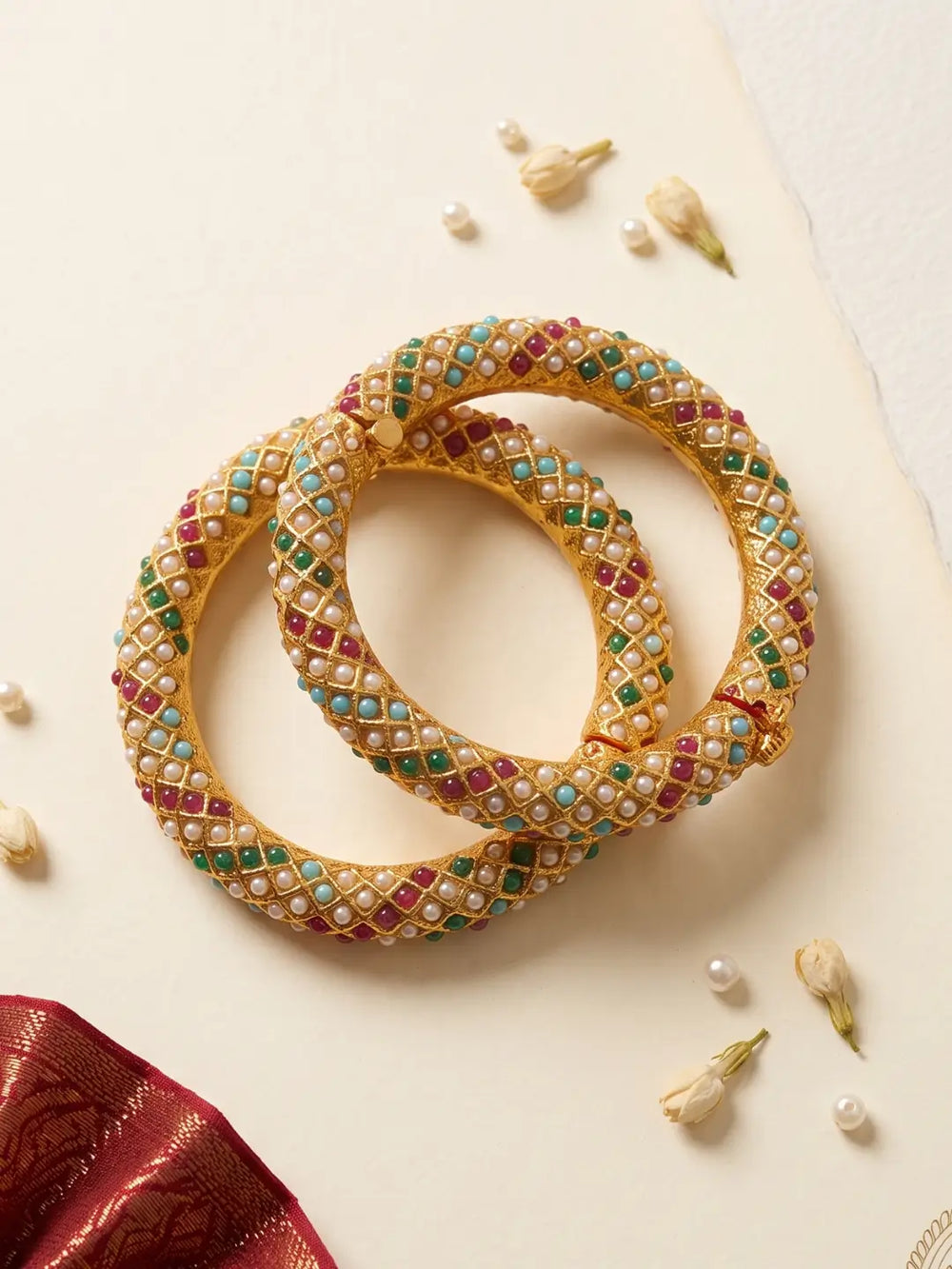 Pink, green and blue Jadau bangles with pearl-style accents and gold-plated detailing, designed for weddings, mehendi and festive celebrations.